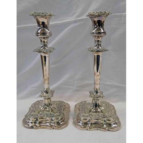 213 - PAIR OF 19TH CENTURY SILVER PLATED CANDLESTICKS ON SHAPED SQUARE BASES - 33CM TALL