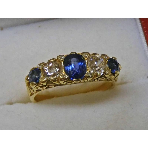 97 - SAPPHIRE & DIAMOND 5 - STONE RING, THE CENTRAL OVAL SAPPHIRE FLANKED BY 2 CIRCULAR CUT DIAMONDS & 2 ... 