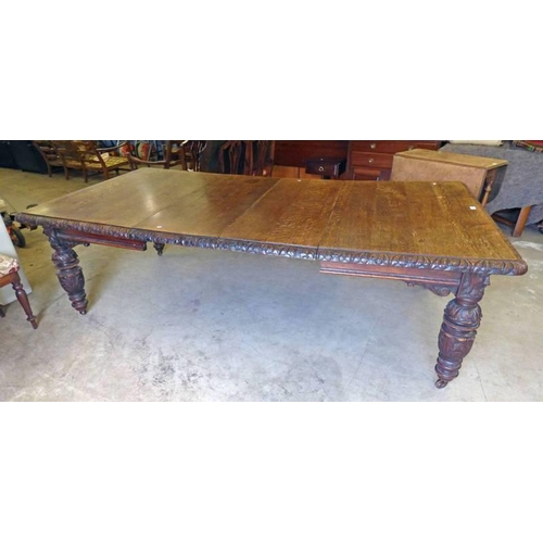 5035 - 19TH CENTURY CARVED OAK EXTENDING TABLE WITH ADDITIONAL LEAVES ON TURNED SUPPORTS.  LENGTH 24 CM