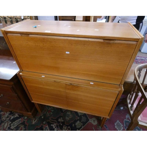 183 - 20TH CENTURY TEAK COCKTAIL CABINET WITH FALL FRONT OVER 3 PANEL DOORS