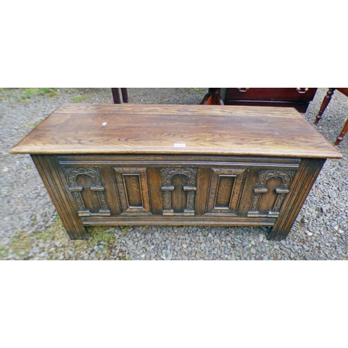186 - 19TH CENTURY STYLE CARVED OAK COFFER ON SQUARE SUPPORTS.  LENGTH 114 CM