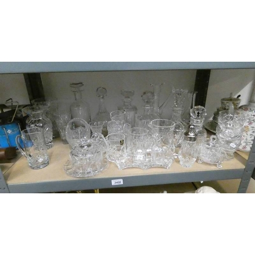 3406 - LARGE SELECTION CRYSTAL DECANTERS, JUGS, BOWLS ETC OVER ONE SHELF