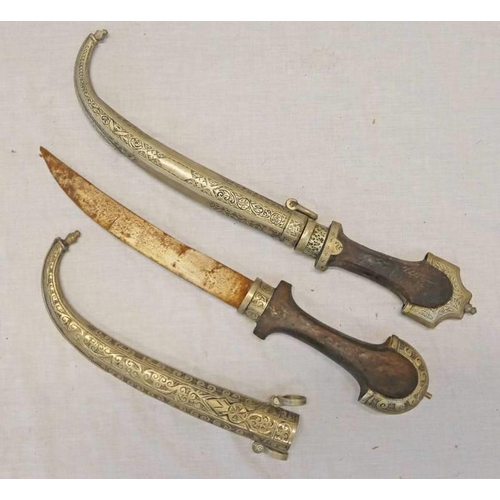 1053 - 2 NORTH AFRICAN JAMBIYAS WITH WHITE METAL MOUNTS & SCABBARDS