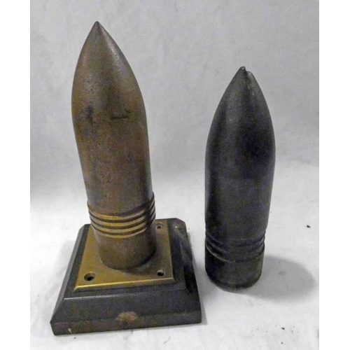 1089 - TWO WORLD WAR ONE PERIOD PROJECTILE HEADS, ONE ON STAND -2-