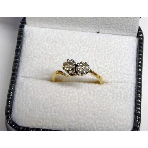 64 - 18CT GOLD 2-STONE DIAMOND TWIST RING, APPROX. 0.6 CARATS IN TOTAL