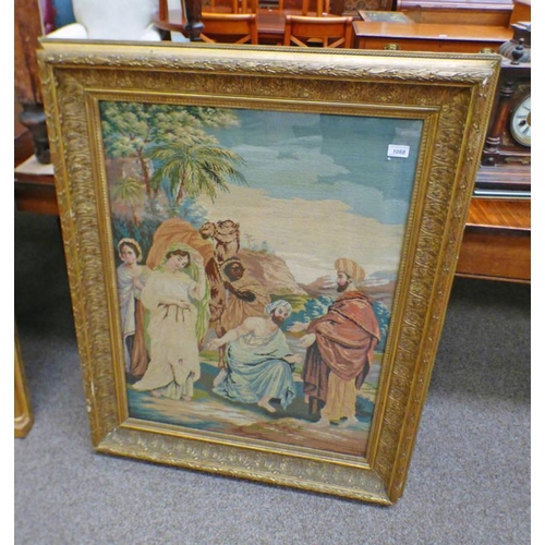 1068 - GILT FRAMED WOOLWORK TAPESTRY OF A BIBLICAL SCENE. 84 CM X 63 CM