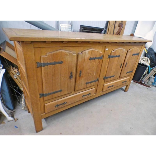 29 - OAK CABINET WITH 4 PANEL DOORS OVER 2 DRAWERS, LENGTH 241CM (AS FOUND, NO BACK)