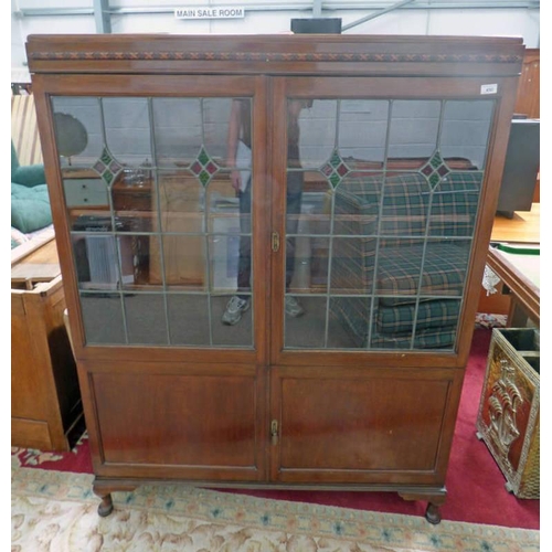 31 - EARLY 20TH CENTURY MAHOGANY BOOKCASE WITH 2 LEADED GLASS PANEL DOORS OVER 2 PANEL DOORS ON SHORT QUE... 