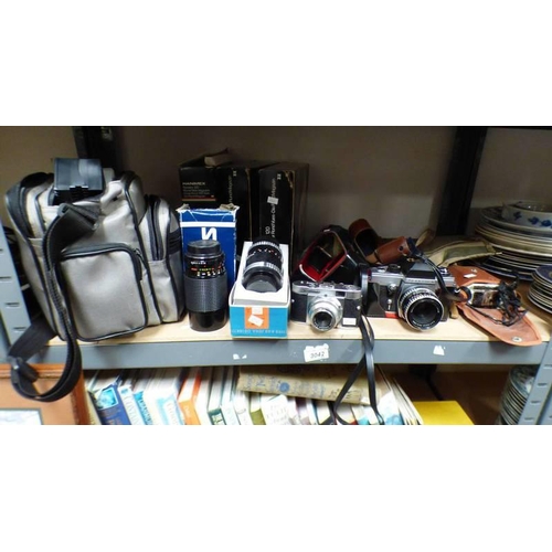 3042 - PRAKTICA CAMERA, VOIGHTLANDER CAMERA, 2 LENSES, CAMERA BAG, SLIDE TRAP, ETC ON 1 SHELF