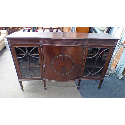 600 - LATE 19TH CENTURY CARVED MAHOGANY BOOKCASE WITH BOW FRONT PANEL DOOR FLANKED BY 2 ASTRAGAL GLASS PAN... 