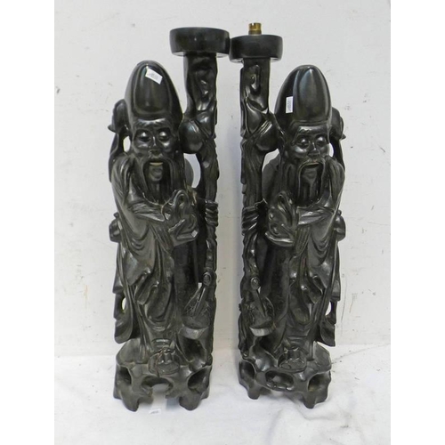 1487 - PAIR OF CARVED ORIENTAL TABLE LAMP BODIES IN THE FORM OF MONKS 57 CM TALL