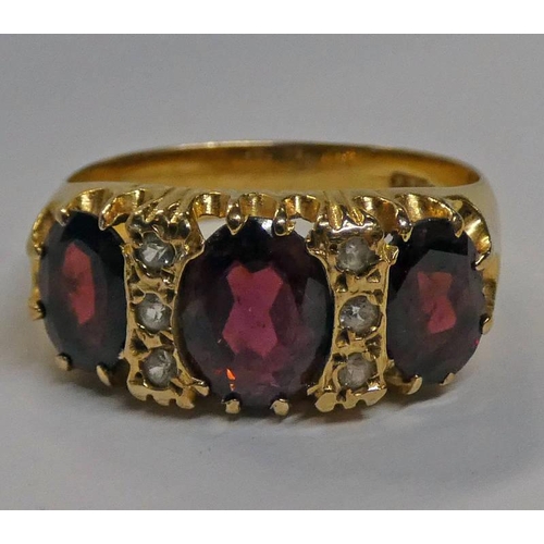 376 - 9CT GOLD GARNET SET RING -4.3 G