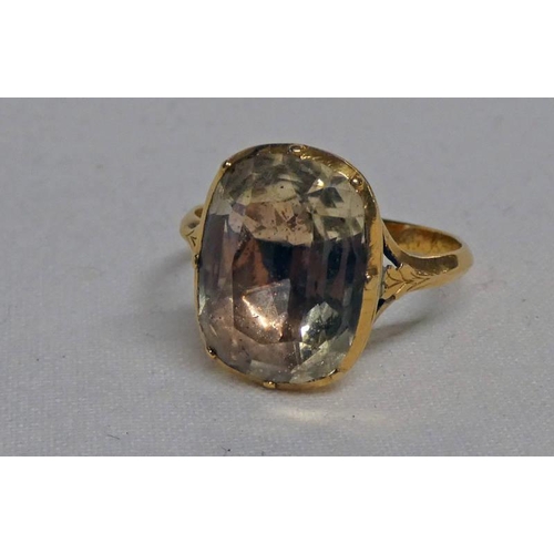 628 - 19TH CENTURY YELLOW METAL GEM SET RING, THE OVAL FACETED STONE IN A SOLID BACK MOUNT WITH HAND DOTTE... 