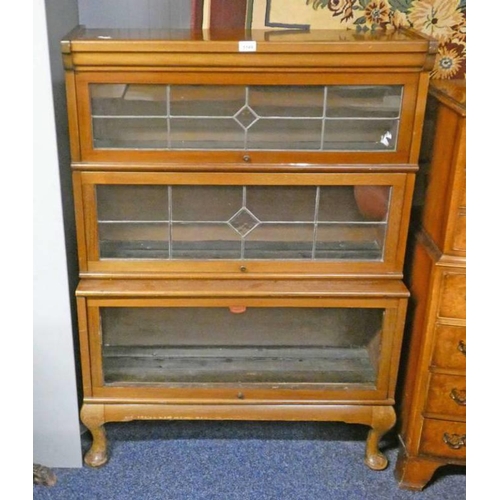 209 - MAHOGANY SECTIONAL BOOKCASE WITH 2 LEADED GLASS PANEL DOORS OVER PANEL DOOR ON SHORT QUEEN ANNE SUPP... 