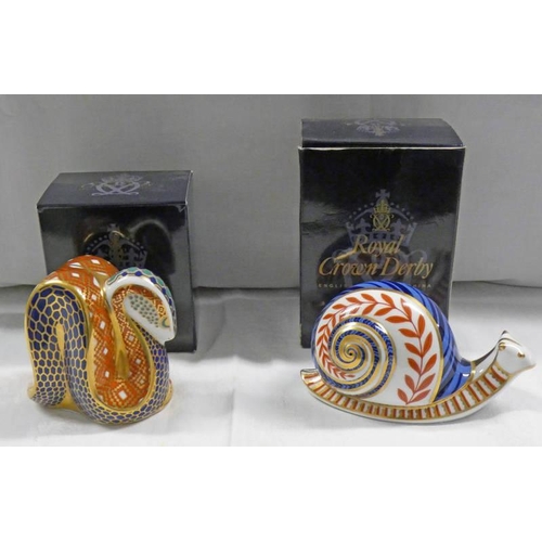 3093 - 2 ROYAL CROWN DERBY IMARI PAPERWEIGHTS, SNAIL, WITHOUT STOPPER AND SNAKE, GOLD STOPPER AND BOX