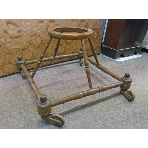 518 - 19TH/ EARLY 20TH CENTURY MAHOGANY BABY WALKER WITH TURNED DECORATION