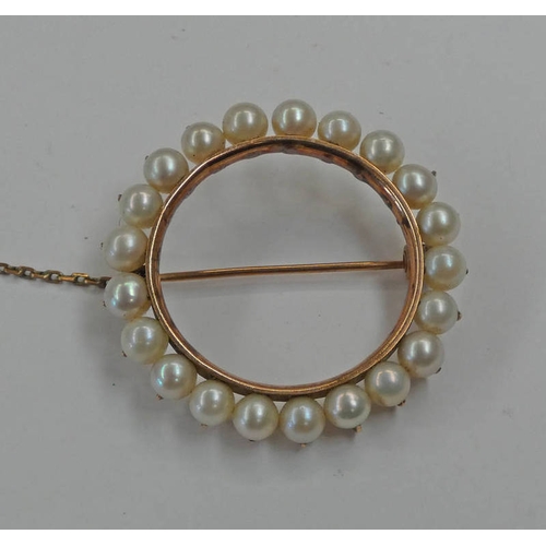 141 - CIRCULAR PEARL SET BROOCH IN A YELLOW METAL MOUNT - 3CM DIAMETER