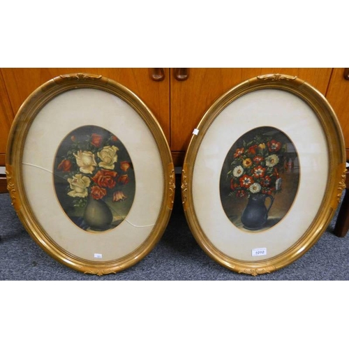 1010 - 2 OVAL GILT FRAMED OIL PAINTINGS OF FLOWERS BOTH WITH THE NAME WILLIAM SCHMALTZ 1944 TO REVERSE, 27 ... 