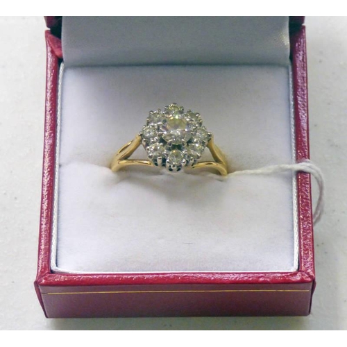 13 - 18CT GOLD DIAMOND CLUSTER RING THE CENTRE STONE OF APPROX 0.47 CARAT IN A SURROUND OF EIGHT BRILLIAN... 