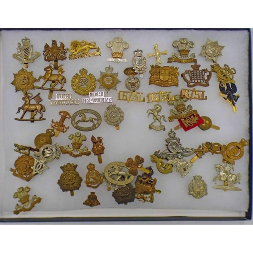 1429 - SELECTION OF VARIOUS BRITISH CAP BADGES IN A GLAZED DISPLAY TO INCLUDE DUKE OF LANCASTERS OWN, MIDDL... 