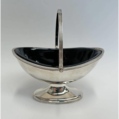 77 - SILVER OVAL SWING HANDLED SALT WITH BLUE GLASS LINER, LONDON 1967 - 90 G WEIGHABLE SILVER