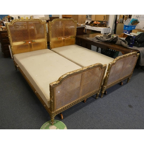 10 - PAIR OF 19TH CENTURY GILT SINGLE BED FRAMES WITH BERGERE PANELS ON REEDED SUPPORTS. TOTAL WIDTH 100 ... 