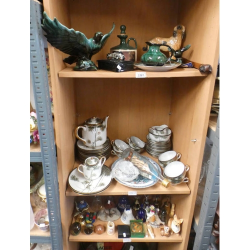 3381 - 2 SHELVES OF ORIENTAL TEASETS, BLUE MOUNTAIN POTTERY, SHIP IN BOTTLE, GLASSWARE, BELLS, ETC