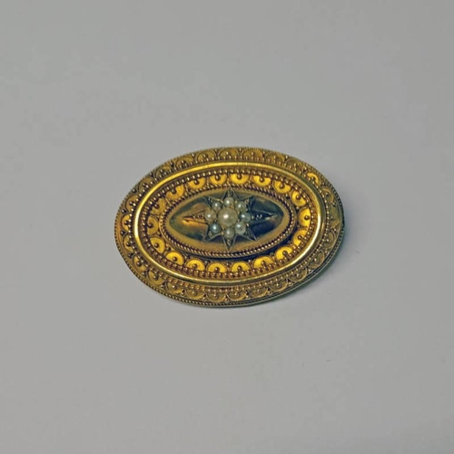 17 - 19TH CENTURY GOLD OVAL BROOCH WITH PEARL STARBURST DECORATION - 4.5 CM WIDE