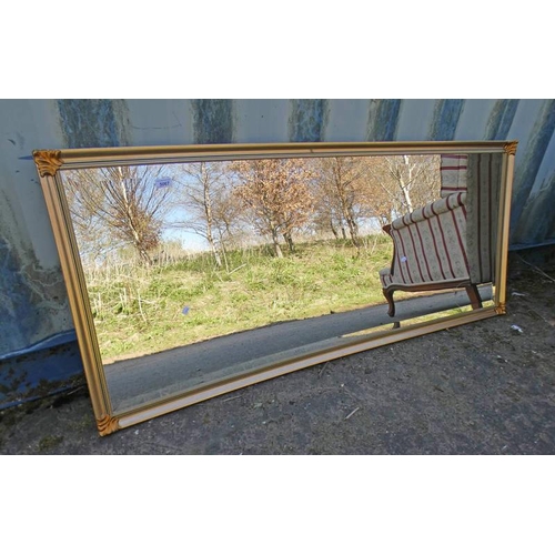 5067 - GILT FRAMED RECTANGULAR MIRROR WITH BEVELLED EDGE.  58 CM TALL X 148 CM WIDE