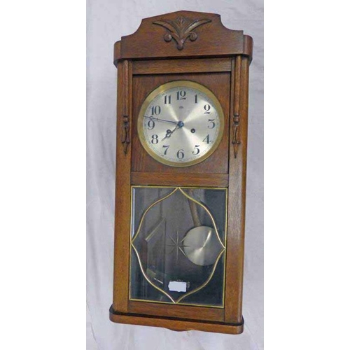 5076 - EARLY 20TH CENTURY OAK CASED WALL CLOCK BY HALLER A G, OVERALL LENGTH 77CM