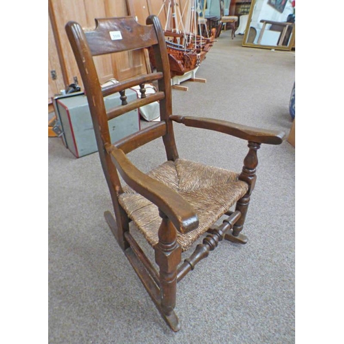 5509 - MAHOGANY FRAMED CHILD'S ROCKING CHAIR WITH RUSHWORK SEAT