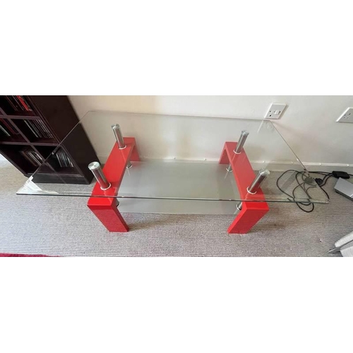 536 - GLASS TOPPED COFFEE TABLE WITH RED SUPPORTS