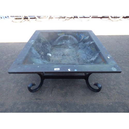 6099 - METAL FIRE PIT ON A CAST METAL BASE.  84 CM WIDE