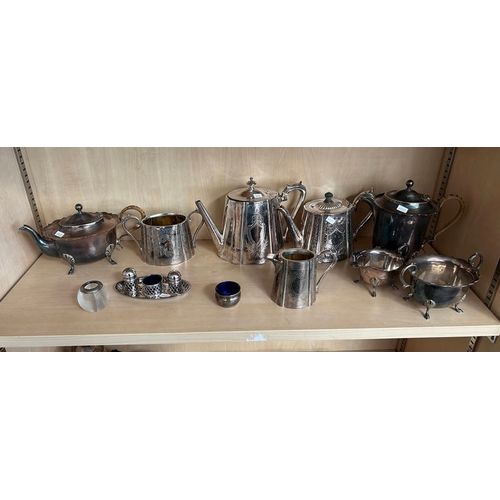 124 - SILVER PLATED TEAPOTS, CONDIMENT SET, SILVER RIMMED GLASS CANDLE HOLDER ETC OVER 1 SHELF