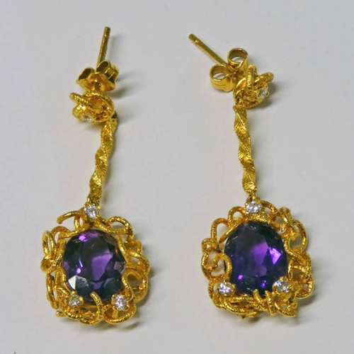 235 - PAIR OF AMETHYST & DIAMOND EAR DROPS, THE OVAL FACETED AMETHYST SET WITHIN A DECORATIVE MOUNT STUDDE... 