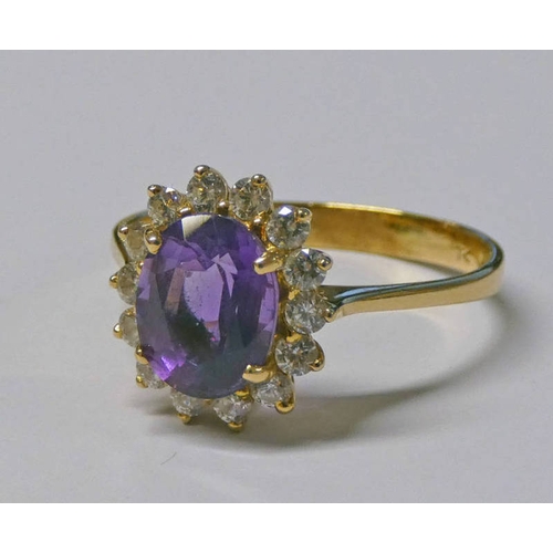 325 - 14K GOLD AMETHYST & DIAMOND CLUSTER RING, THE OVAL AMETHYST SET WITHIN A SURROUND OF 14 DIAMONDS APP... 