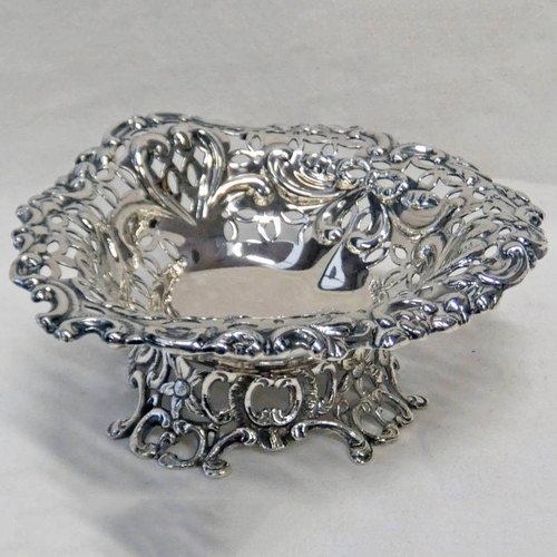 388 - SILVER HEART SHAPED DISH WITH PIERCED DECORATION ON 4 RAISED FEET BY WILLIAM COMYNS, BIRMINGHAM 1893... 