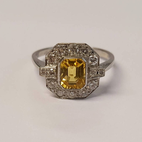 410 - ART DECO STYLE PLATINUM SET YELLOW SAPPHIRE & DIAMOND CLUSTER RING, THE OVAL FACETED SAPPHIRE SET BE... 