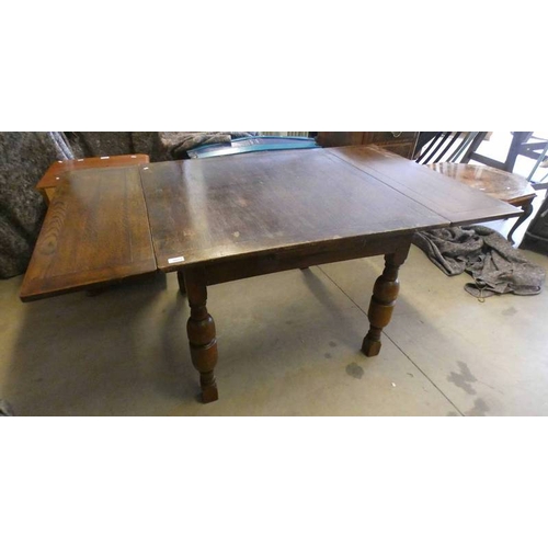 5012 - EARLY 20TH CENTURY OAK DRAW LEAF DINING TABLE ON BALUSTER SUPPORTS LABELLED LEBUS FURNITURE, 152CM