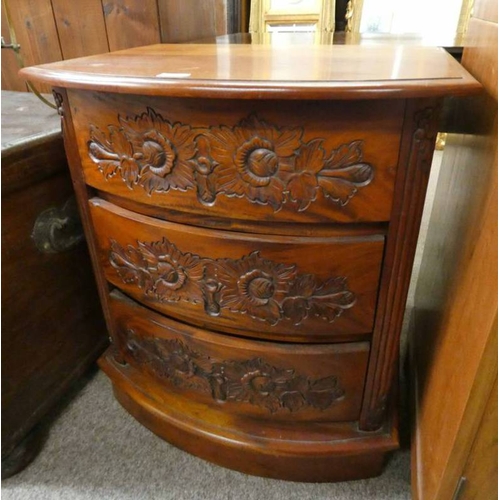 5030 - BOWFRONT TEAK CHEST OF DRAWERS WITH CARVED DECORATION. LENGTH 64 CMS