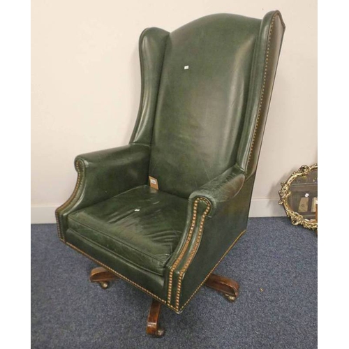 5031 - 20TH CENTURY GREEN LEATHER OVERSTUFFED WINGBACK SWIVEL CHAIR ON 5 SPREADING OAK SUPPORTS.  - SOLD PL... 