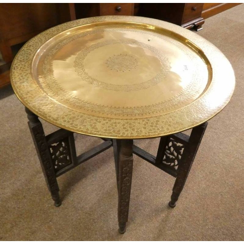 5113 - CIRCULAR BRASS TOPPED EASTERN TABLE WITH ETCHED ORIENTAL DECORATION ON FOLDING HARDWOOD BASE WITH CA... 