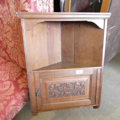 126 - MAHOGANY WALL HANGING CORNER CABINET WITH DECORATIVE CARVED PANEL DOOR, 61CM TALL