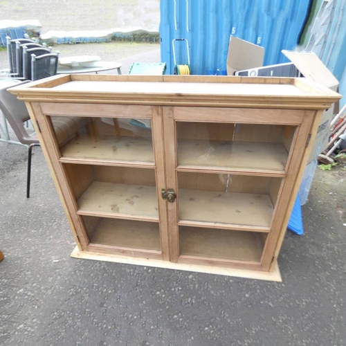 30 - PINE BOOKCASE WITH 2 GLAZED PANEL DOORS OPENING TO SHELVED INTERIOR, 91CM TALL X 111CM WIDE