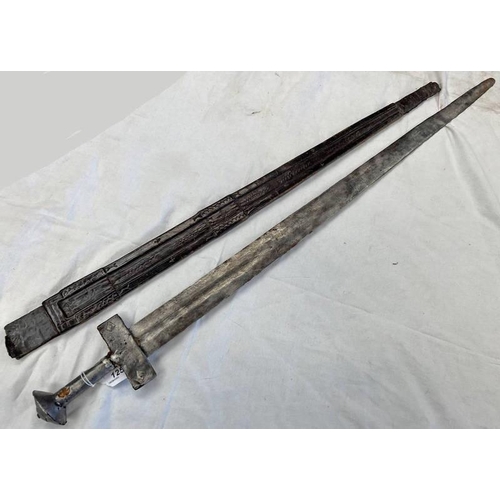 1254 - AFRICAN TAKOUBA SWORD WITH A 86CM DOUBLE EDGED BLADE, SHEET STEEL HILT & A LEATHER SCABBARD