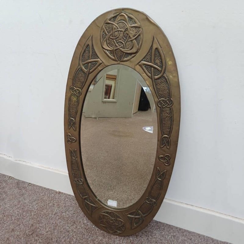 1024 - ARTS & CRAFTS STYLE BRASS FRAMED MIRROR WITH CELTIC KNOT DECORATION, 57 X 29 CM (EXCLUDING FRAME)