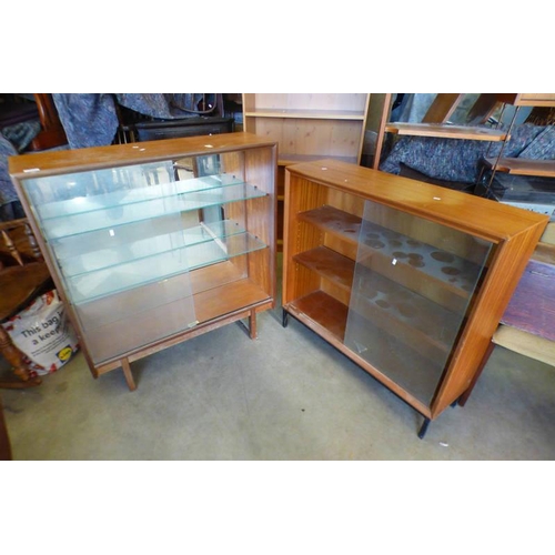 128 - PAIR OF TEAK SLIDING GLASS DOOR BOOKCASE MARKED TURNIDGE OF LONDON / GIBBS FURNITURE .  HEIGHT 100 C... 