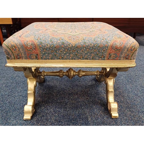 5035 - CARVED GILT SQUARE STOOL WITH PADDED TOP ON X - SUPPORTS.  43 CM TALL X 53 CM WIDE