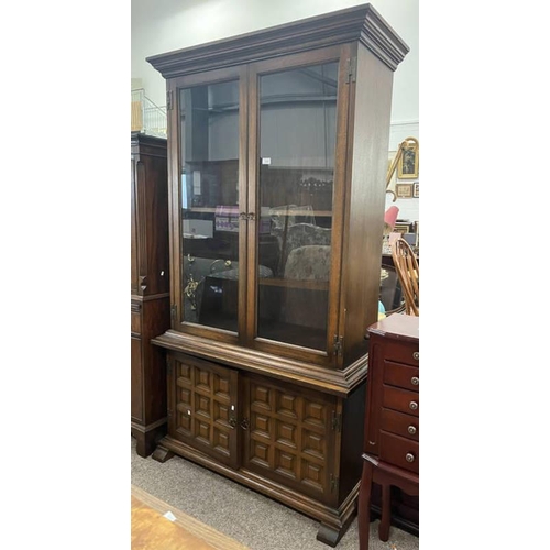 113 - OAK BOOKCASE WITH 2 GLAZED DOORS OVER 2 PANEL DOORS, 184CM TALL