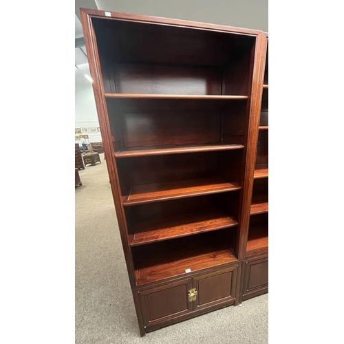 169 - ORIENTAL HARDWOOD OPEN BOOKCASE WITH SHELVES OVER 2 PANEL DOORS, 203CM TALL